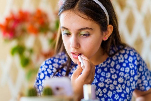 Young girl following an online makeup course