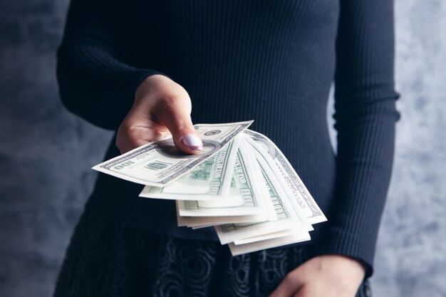 Young girl gives dollar bills