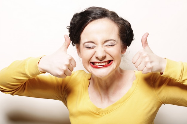 Young girl gives thumb up with two hands