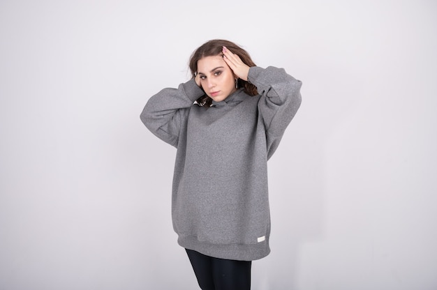 Young girl in a gray sweatshirt.