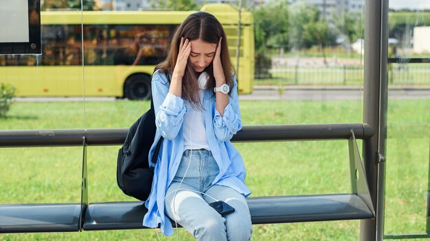 Young girl has broken down smartphone. Broken phone screen.