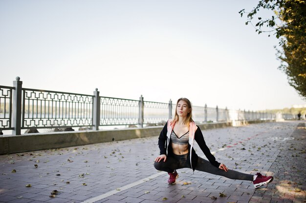 Young girl has the training and doing exercise outdoors