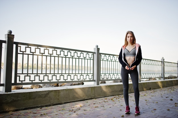 Young girl has the training and doing exercise outdoors