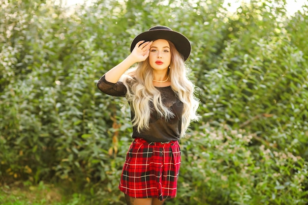 A young girl in a hat looking at the autumn landscape