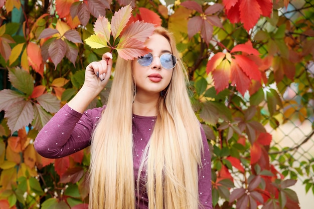 A young girl in a hat looking at the autumn landscape