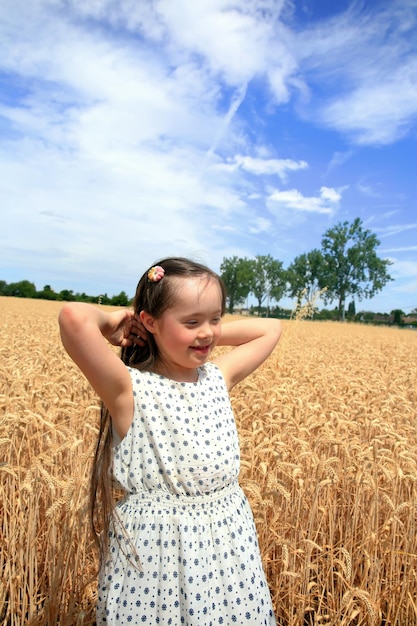 Young girl have fun in the wheat field