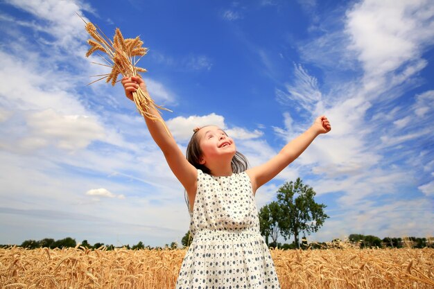 Young girl have fun in the wheat field