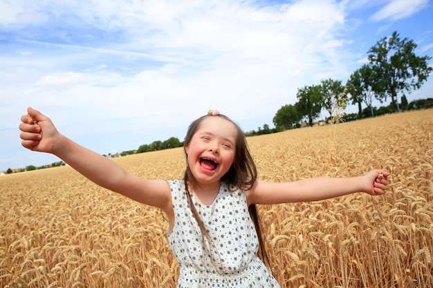 Young girl have fun in the wheat field