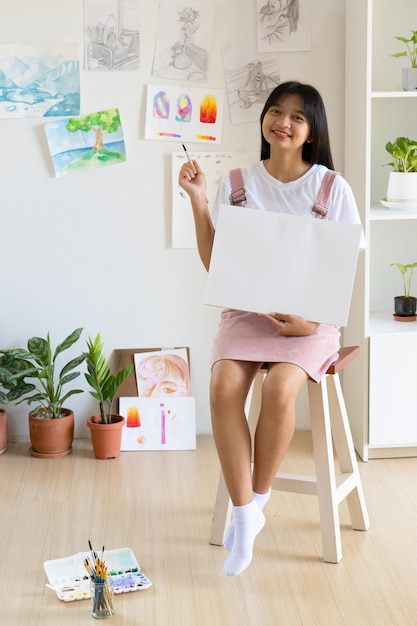 Young girl hold frame and paper at home Hobby and art study at home