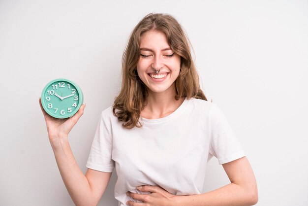 Young girl holding an alarm clock wake up concept