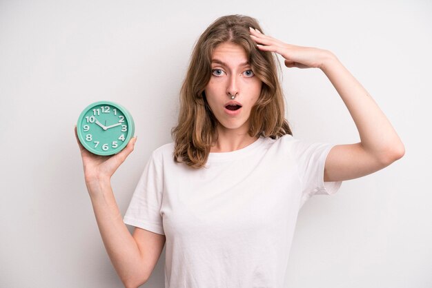 Young girl holding an alarm clock wake up concept