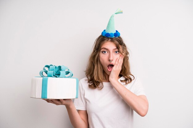 Young girl holding a birthday cake