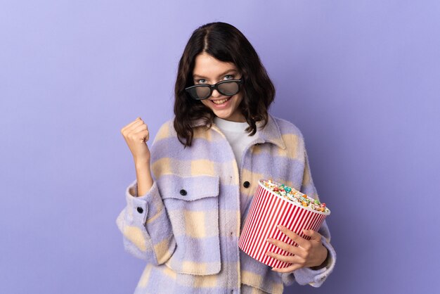 Young girl holding bowl of popcorn