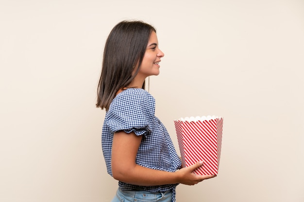 Young girl holding a bowl of popcorns