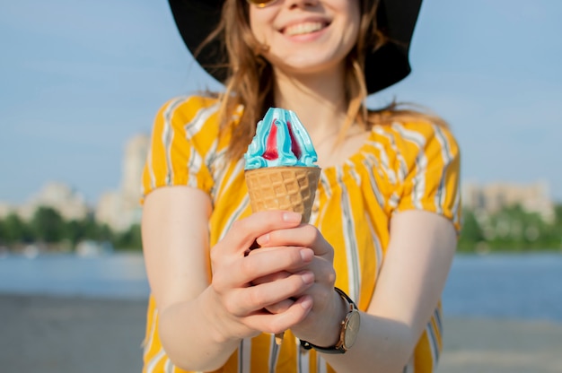 Young girl holding a cone with ice cream