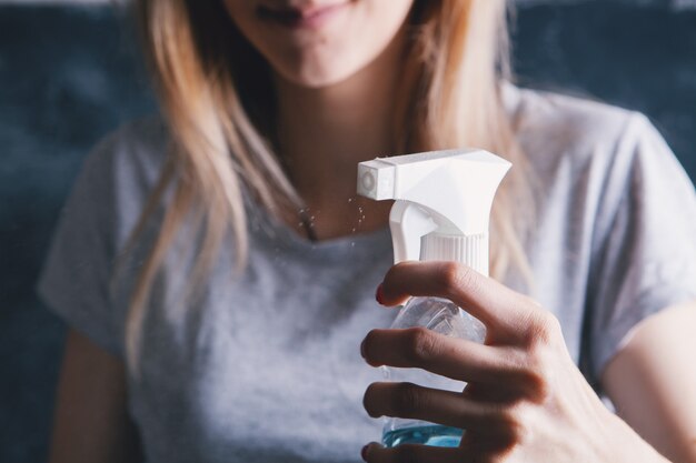 Young girl holding glass detergent