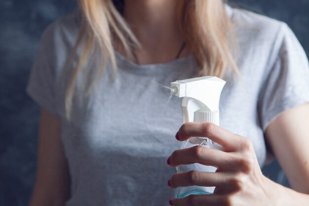 Young girl holding glass detergent