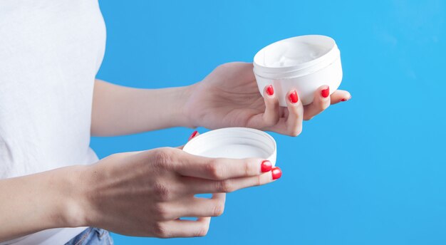 Young girl holding hand cream