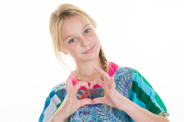 Young girl holding hands in heart shape framing isolated