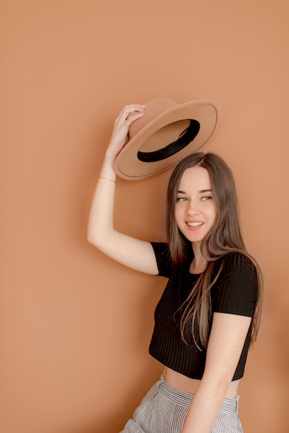 Young girl holding hat