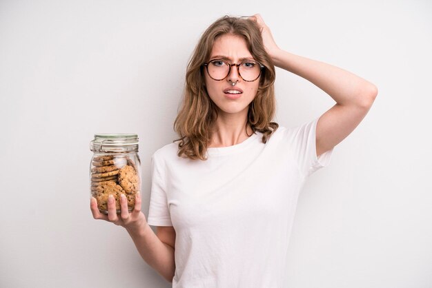 Young girl holding home made cookies bottle