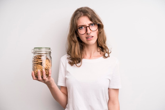 Young girl holding home made cookies bottle