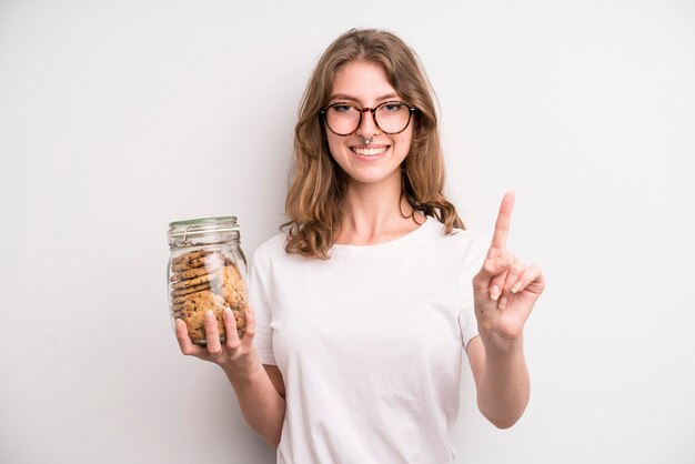 Young girl holding home made cookies bottle