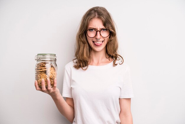 Young girl holding home made cookies bottle