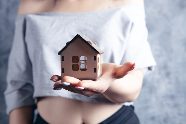 Young girl holding a house