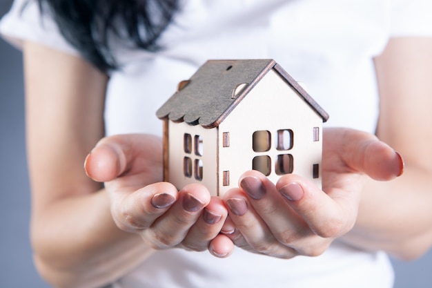 Young girl holding a house