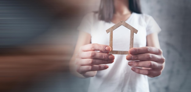 Young girl holding a house