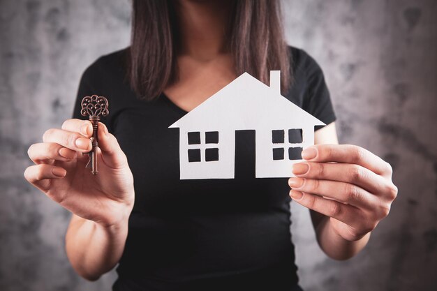 Young girl holding a house