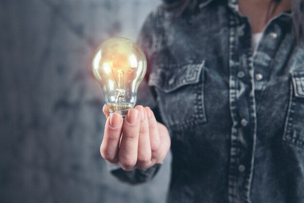 Young girl holding a light bulb