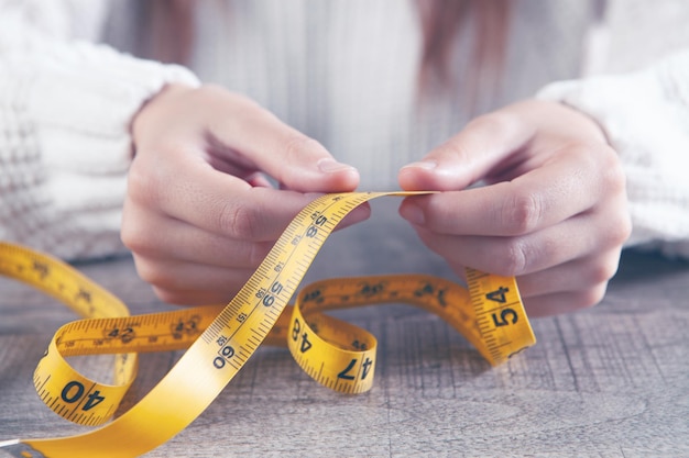 Young girl holding a measuring tape