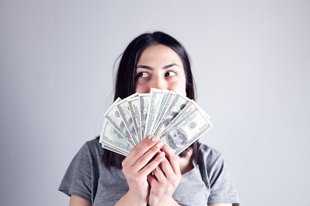 Young girl holding money and looking to the side