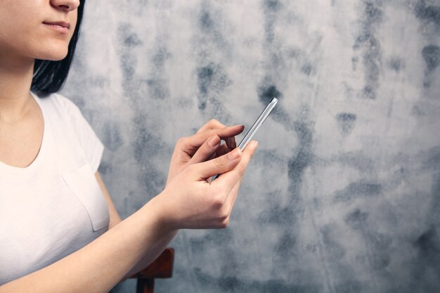 A young girl holding a phone in her hands