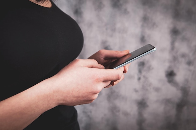 A young girl holding a phone in her hands