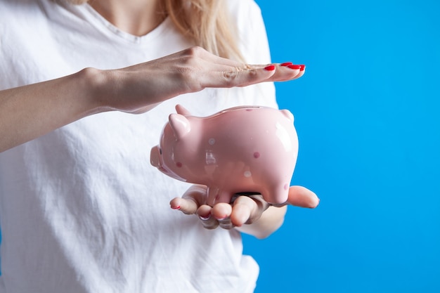 Young girl holding a piggy bank