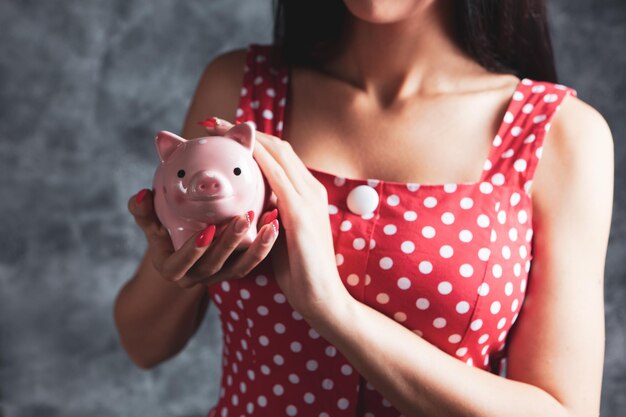 Young girl holding a piggy bank