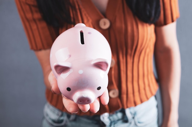 Young girl holding a piggy bank