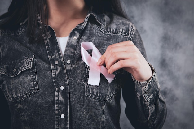 Young Girl Holding A Pink Ribbon