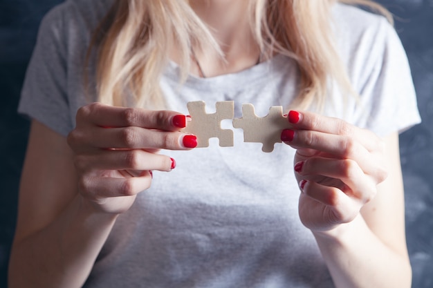 Young girl holding puzzle pieces