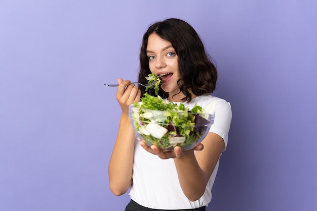 Young girl holding a salad