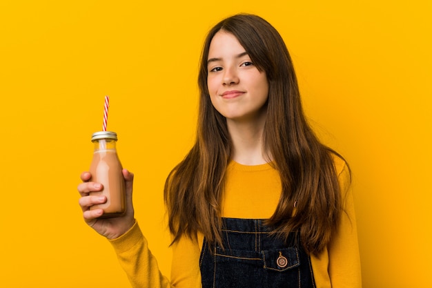 Young girl holding a smoothie