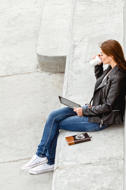 A young girl holding a tablet in hands