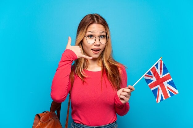 Young girl holding an United Kingdom flag isolated