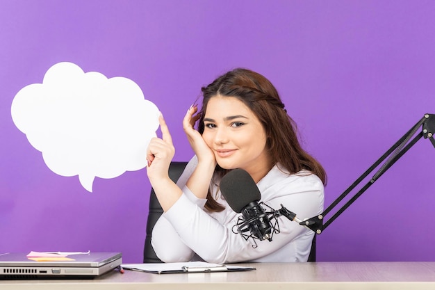 Young girl holding white paper speech bubble in cloud shape and smiling High quality photo