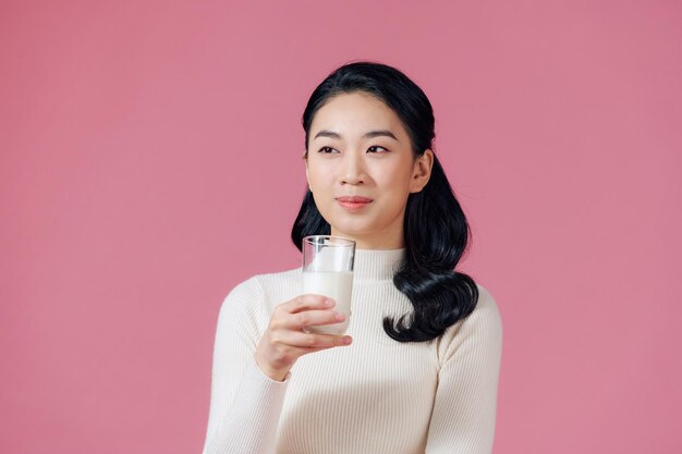 Young girl holds glass of milk