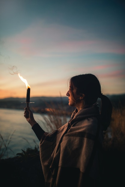 Young girl holds one in hand and looks at the horizon