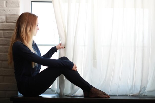 A young girl in a home setting is resting in a big apartment